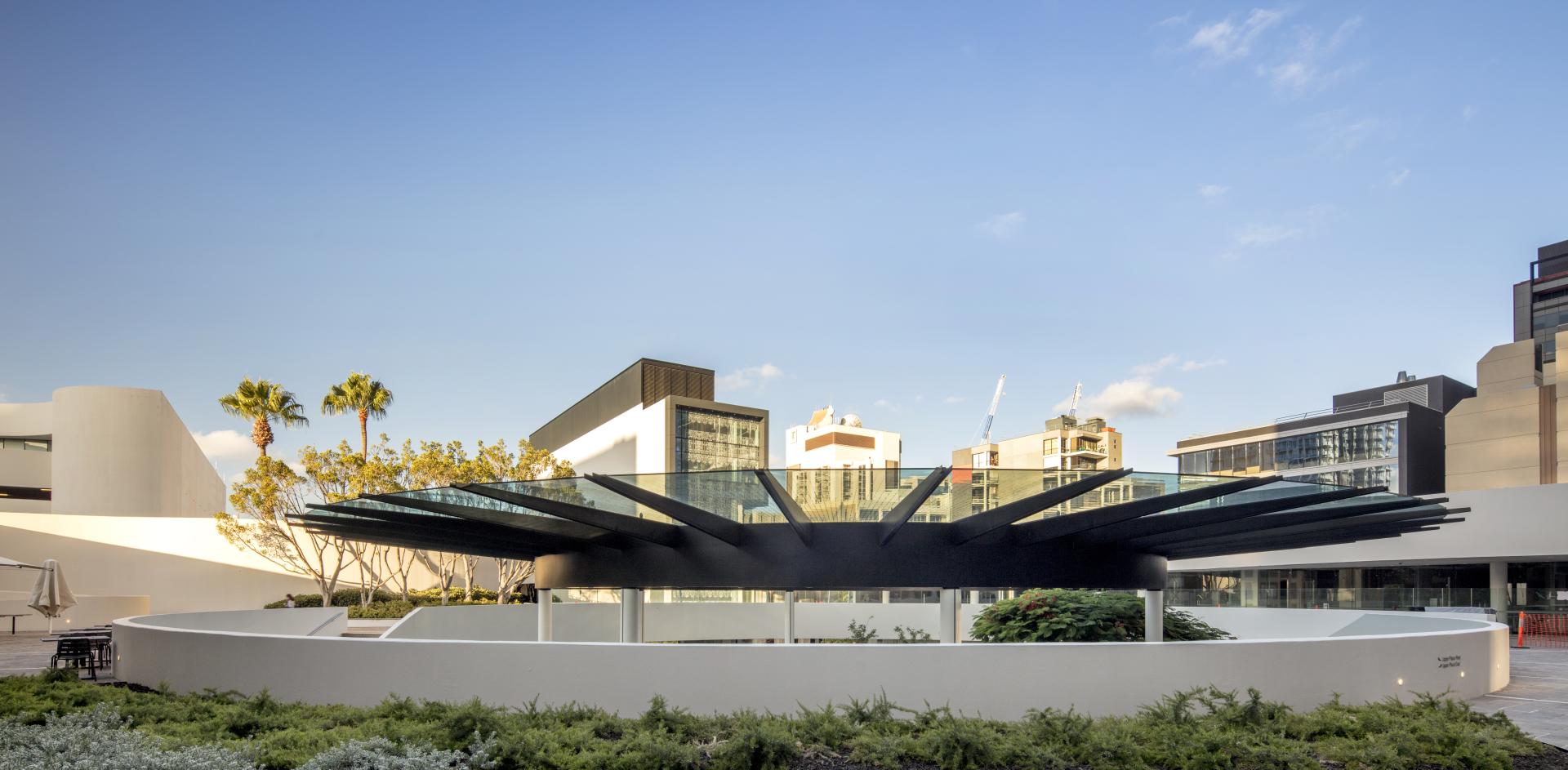 QV1 building with an architectural circular opening in the ceiling front view
